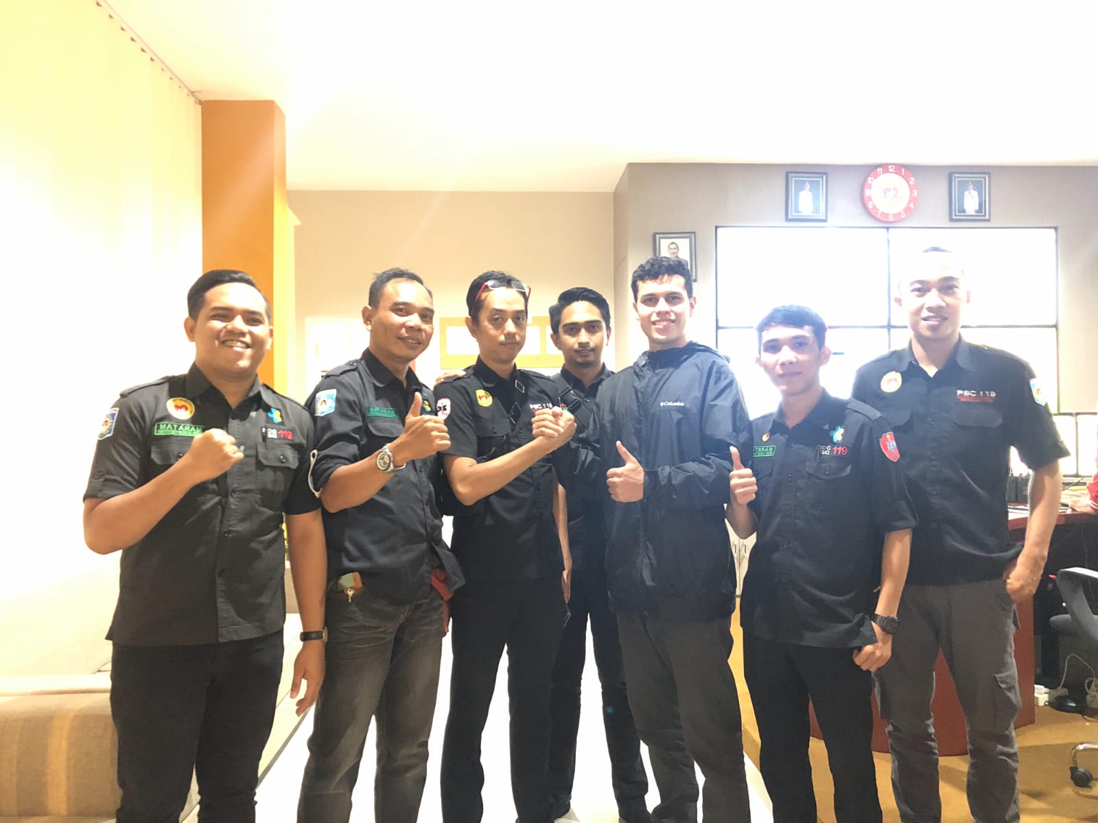 Group of Laos EMS frontline heroes giving thumbs up